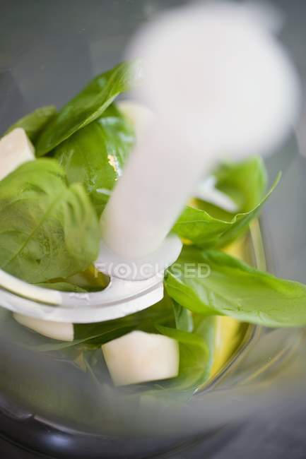 Chopping basil and garlic — Stock Photo