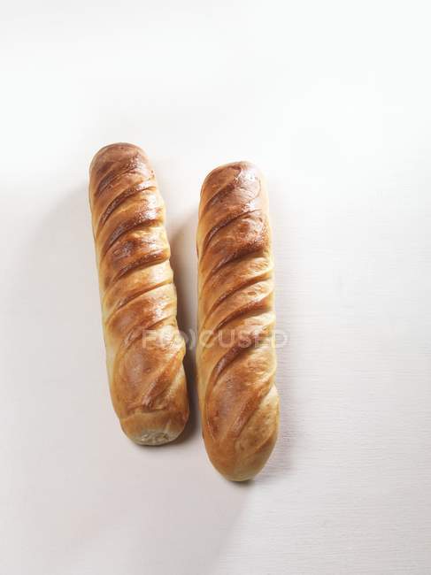 Closeup view of two brioches on white surface — Stock Photo
