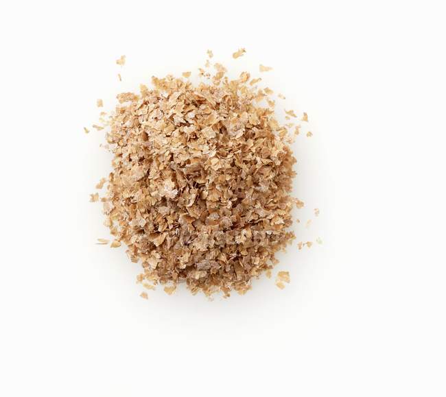 Top view of wheat bran heap on white background — Stock Photo