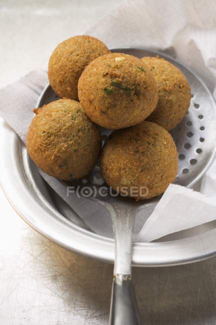 Falafel chickpea balls on slotted spoon — Stock Photo