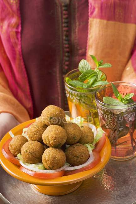 Tray of falafel chickpea balls and tea — Stock Photo
