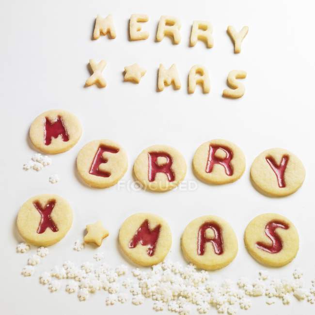 Closeup view of MERRY XMAS biscuits on white surface — Stock Photo