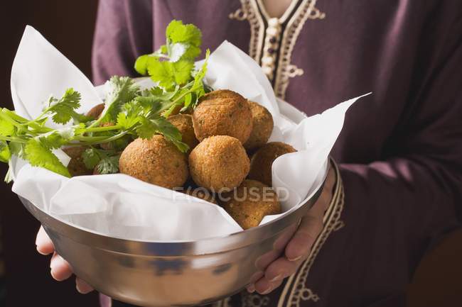 Woman serving falafel chickpea balls — Stock Photo