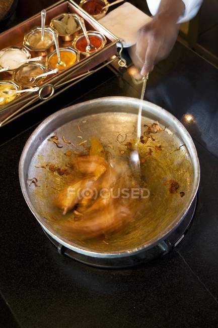 Elevated cropped view of hand mixing Mutton sauce — Stock Photo