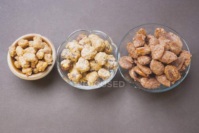 Assorted nuts to nibble in bowls — Stock Photo