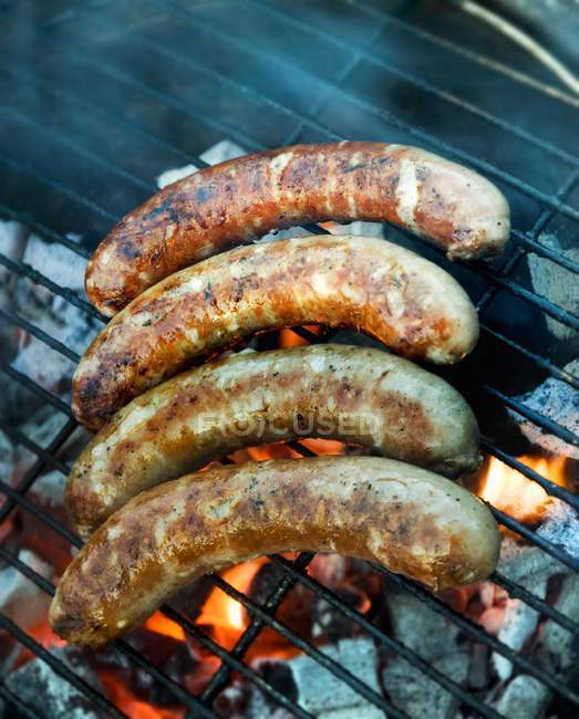 Smoking Sausages on grill — Stock Photo