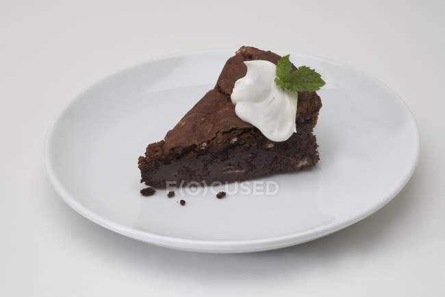 Piece of chocolate cake with cream — Stock Photo