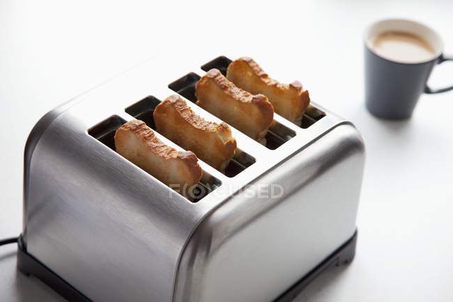 Slices of toasts in toaster — Stock Photo