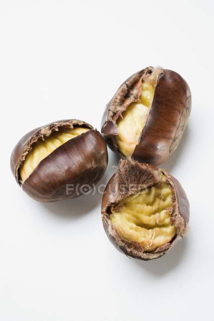Three roasted chestnuts — Stock Photo