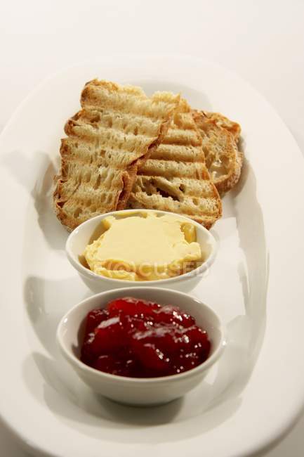 Jam, butter and ciabatta — Stock Photo