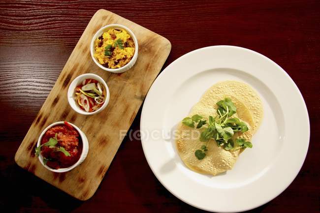 Poppadom with side dishes — Stock Photo