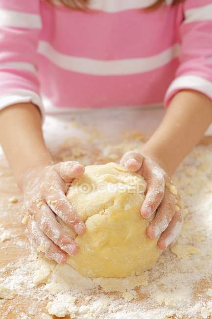 Closeup view of girl kneading shortbread — Stock Photo