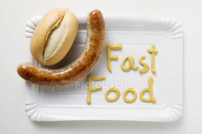 Sausage with bread roll — Stock Photo