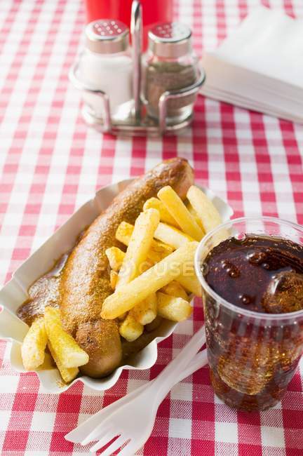 Currywurst sausage with ketchup and curry powder — Stock Photo