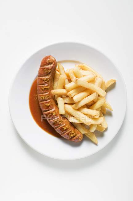 Каррівурстська ковбаса з кетчупом та порошком каррі — стокове фото