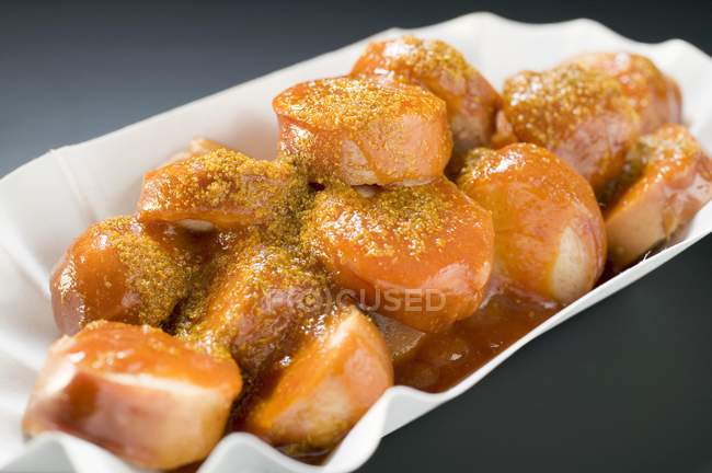 Currywurst sausages with ketchup and curry powder — Stock Photo