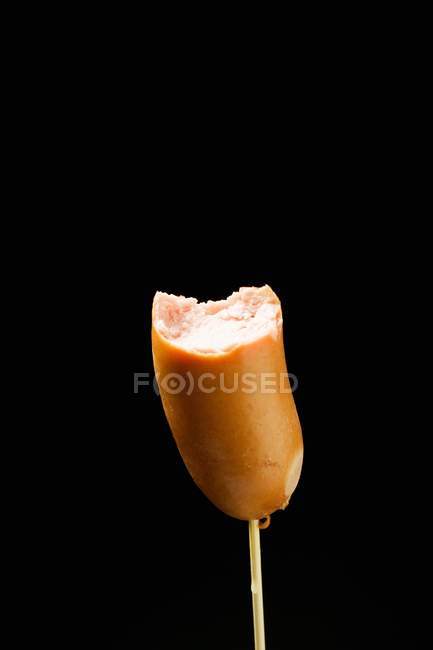 Frankfurter on cocktail stick — Stock Photo