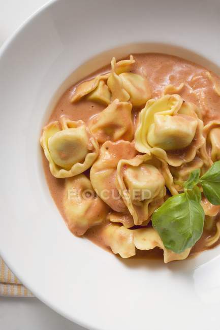 Tortellini pasta with tomato cream sauce — Stock Photo