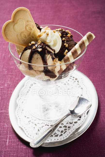 Closeup view of chocolate and nut Sundae with cream and wafers — Stock Photo