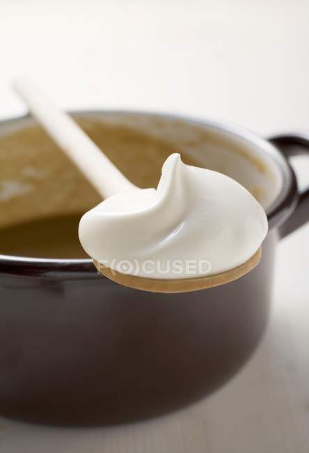 Wooden spoonful of creme frache — Stock Photo