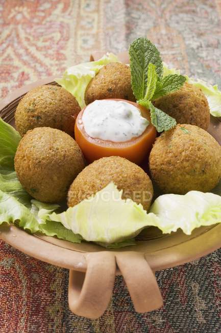 Serving of falafel with stuffed tomato and salad — Stock Photo