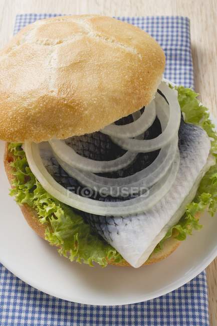 Bread roll filled with herring — Stock Photo