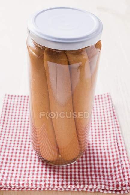 Frankfurters in glass jar — Stock Photo