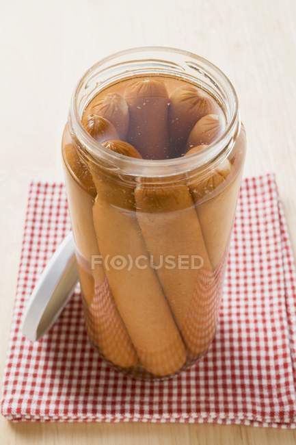 Frankfurters in an opened jar — Stock Photo
