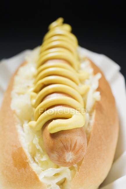 Hot dog with sauerkraut and mustard — Stock Photo
