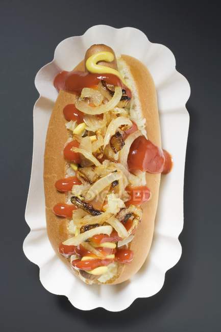 Hot dog with sauerkraut and onions — Stock Photo