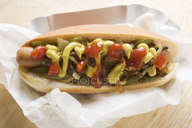 Hot dog with mustard and onions — Stock Photo