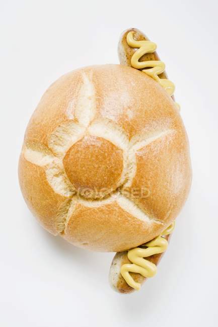 Sausage and mustard in bread roll — Stock Photo