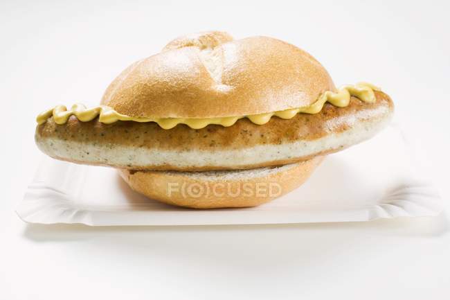 Sausage and mustard in bread roll — Stock Photo