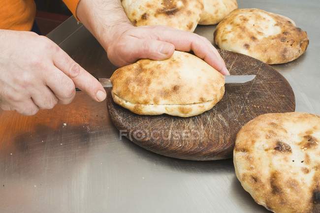 Male hands Splitting pita bread — Stock Photo