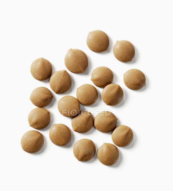 Closeup top view of caramel drops on white surface — Stock Photo