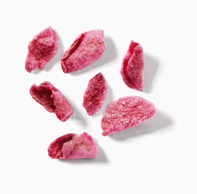 Closeup view of candied rose petals on white surface — Stock Photo