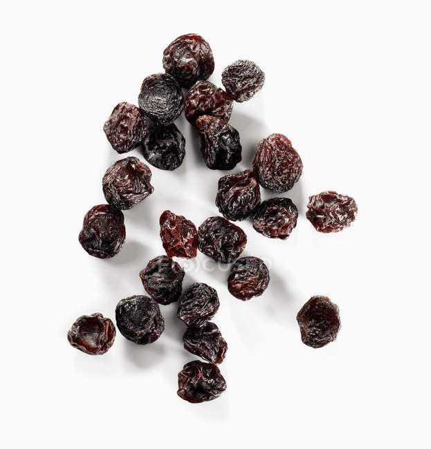 Brown Raisins on white — Stock Photo