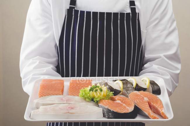 Tray of salmon and sea bass pieces — Stock Photo