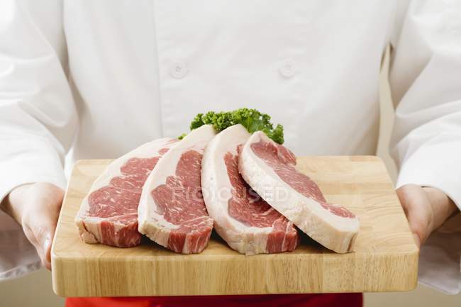 Chef holding sirloin steaks — Stock Photo