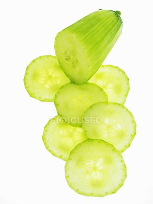 Piece and slices of cucumber — Stock Photo
