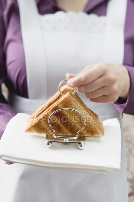 Closeup view of chambermaid serving toasts — Stock Photo