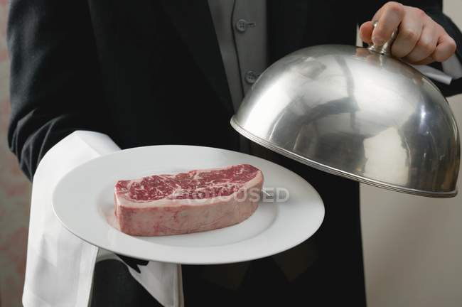 Butler serving beef — Stock Photo