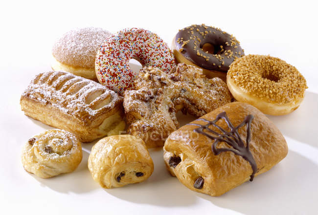 Closeup view of assorted sweet pastries on white surface — Stock Photo