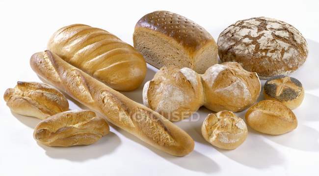 Fresh baked different bread and rolls — Stock Photo