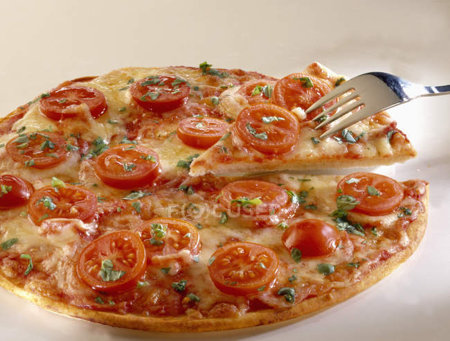Pizza with tomato slices and cheese — Stock Photo