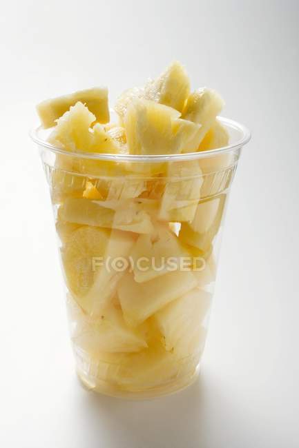 Ananasbrocken im Plastikbecher — Stockfoto