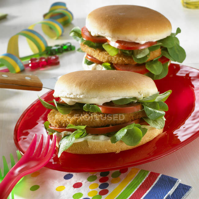 Closeup view of chicken burgers with corn salad — Stock Photo