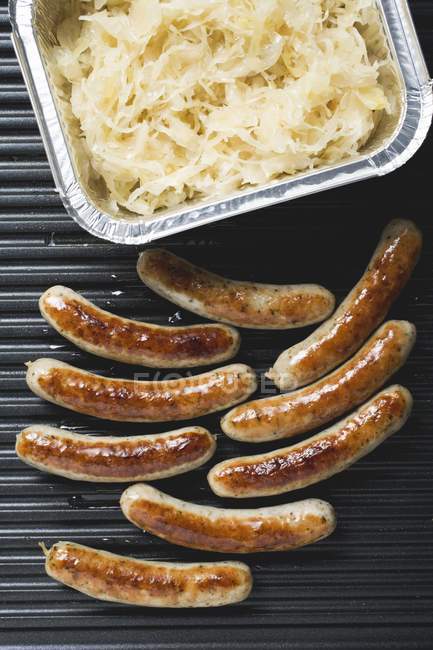 Grilled sausages with sauerkraut — Stock Photo
