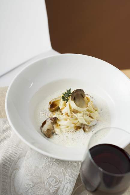 Ribbon pasta with ceps and cream sauce — Stock Photo
