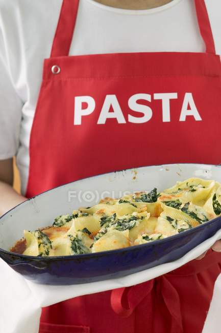 Woman serving pasta dish — Stock Photo